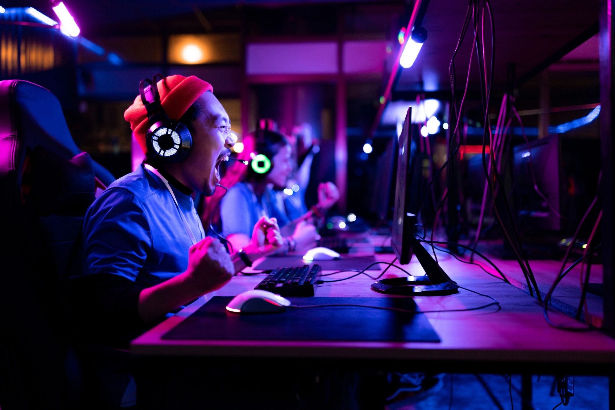 Cheerful gamer celebrating a win in an esports gaming club