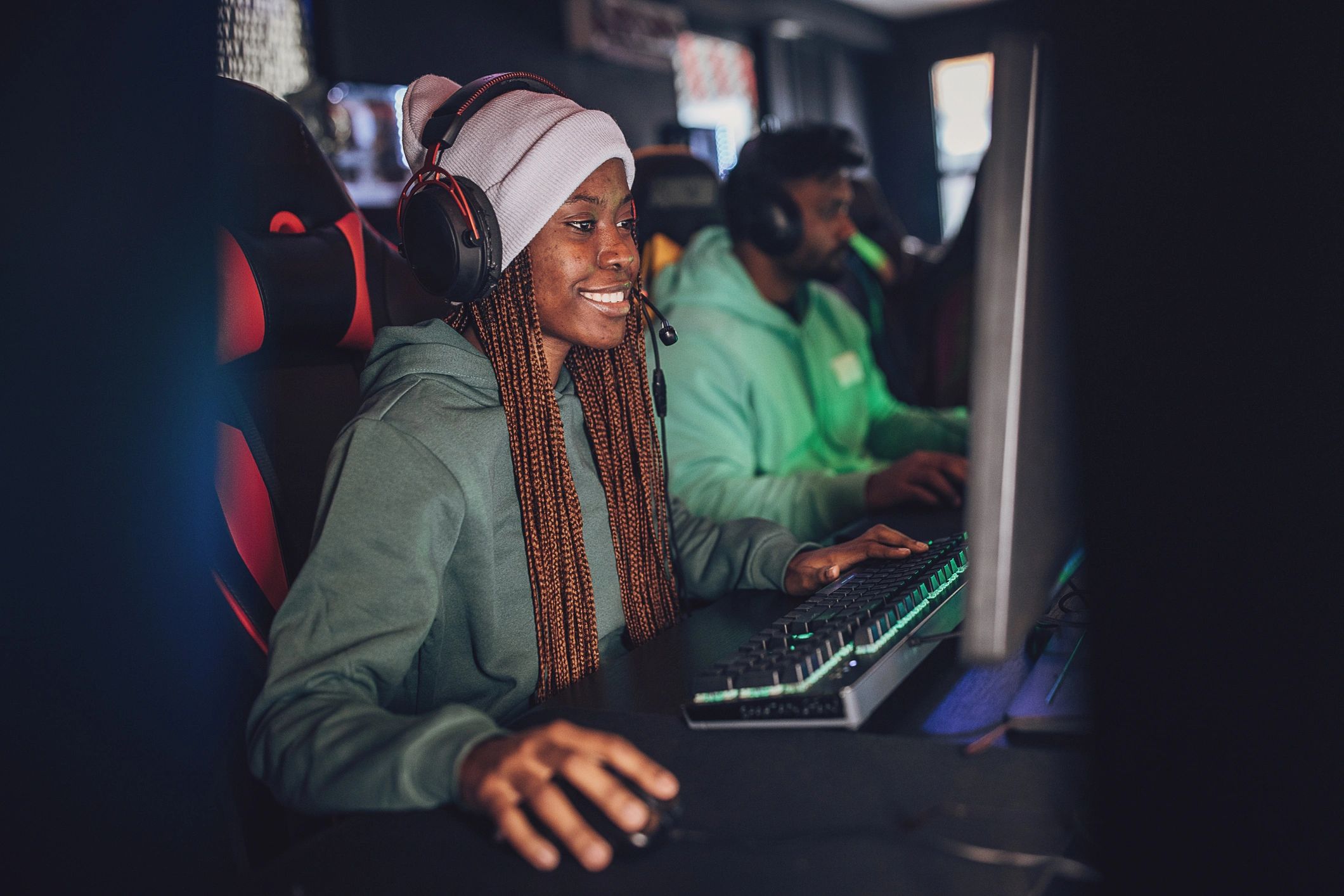 Young gamer playing on PC with friends at a gaming center
